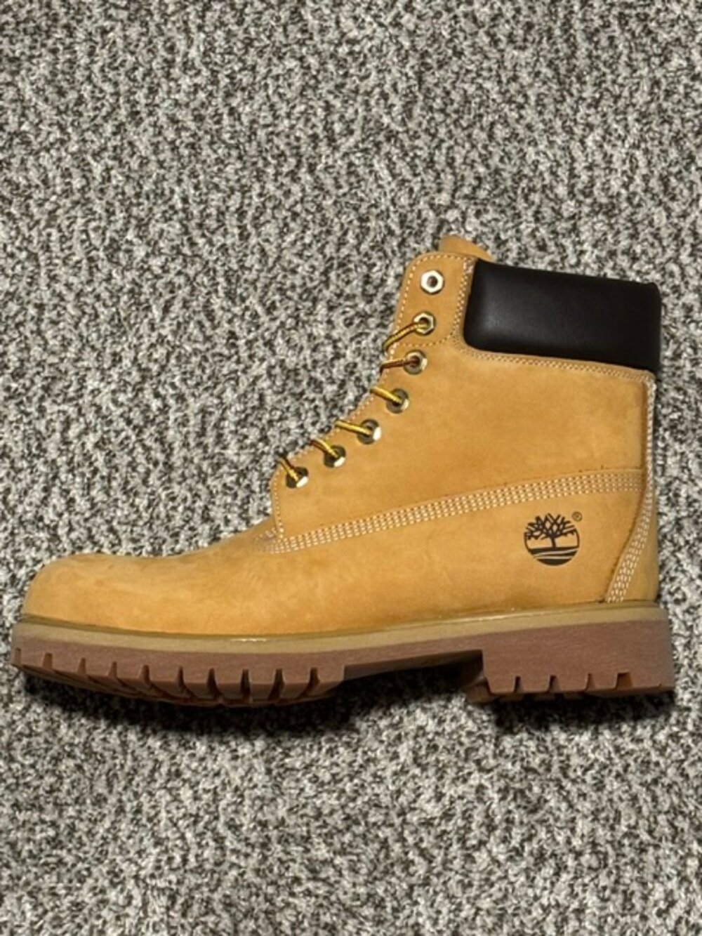 Classic Timberland wheat ankle boots featuring a durable lug sole, padded black